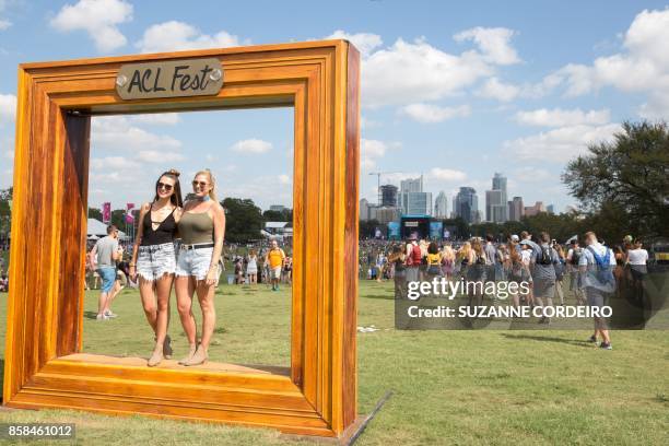 Festgoers pose inside the ACL Fest frame on Day 1 of the 2017 ACL Music Festival held at Zilker Park in Austin, Texas on October 6, 2017.