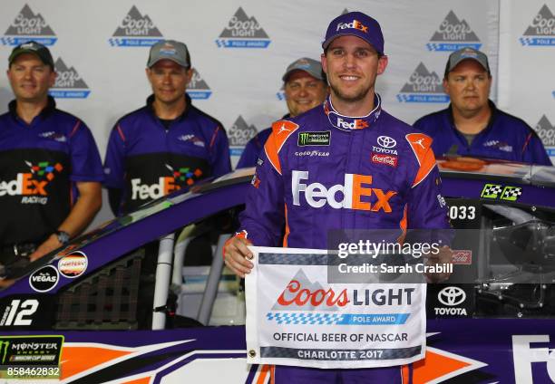 Denny Hamlin, driver of the FedEx Office Toyota, and his team pose with the Coors Light Pole Award after qualifying in the pole position for the...