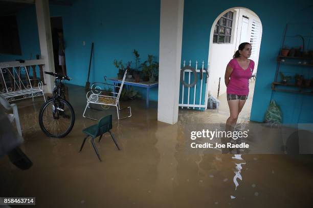 Abigail Maldonado stands in her home inundated with water after a heavy rain passed through following Hurricane Maria on October 6, 2017 in Utuado,...