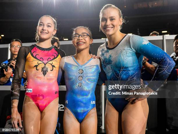 Elena Eremina of Russia , Morgan Hurd of The United States of America and Elsabeth Black of Canada pose for photos after taking the top three...