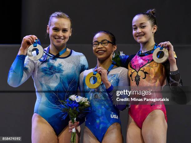 Elsabeth Black of Canada , Morgan Hurd of The United States of America and Elena Eremina of Russia pose with their medals from the podium during the...