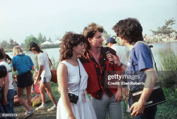 Photo of BONO and U2; Bono and his wife Ali Hewson, backstage at the US Festival at San Bernardino