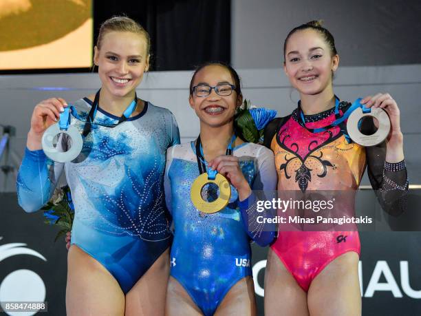 Elsabeth Black of Canada , Morgan Hurd of The United States of America and Elena Eremina of Russia pose with their medals during the women's...