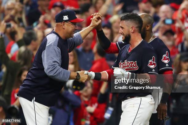 Yan Gomes of the Cleveland Indians celebrates with manager Terry Francona after he hit a an RBI single scoring Austin Jackson to win the game 9 to 8...