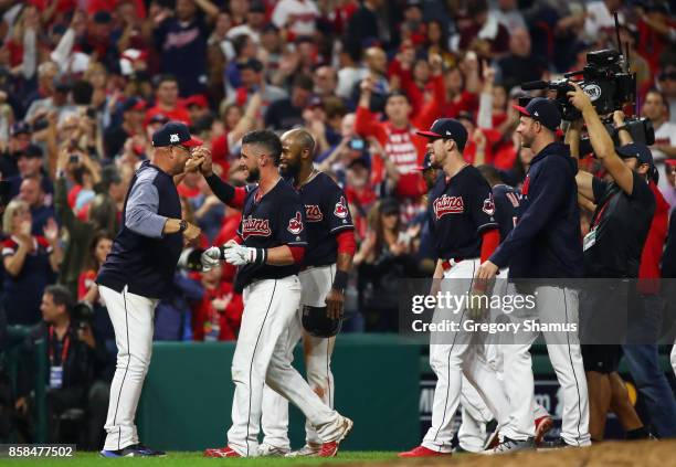 Yan Gomes of the Cleveland Indians celebrates with manager Terry Francona after he hit a an RBI single scoring Austin Jackson to win the game 9 to 8...