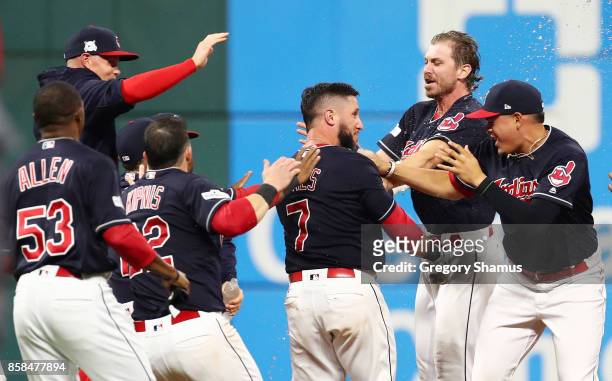 Yan Gomes of the Cleveland Indians celebrates with Josh Tomlin and teammates after he hit a an RBI single scoring Austin Jackson to win the game 9 to...