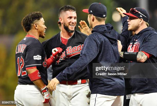 Yan Gomes of the Cleveland Indians celebrates with teammates after he hit a an RBI single scoring Austin Jackson to win the game 9 to 8 in the 13th...