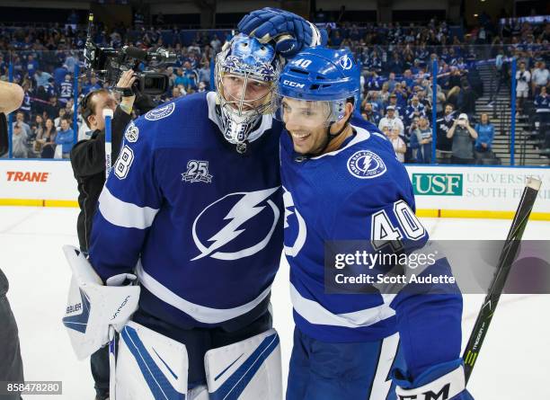 Goalie Andrei Vasilevskiy and Gabriel Dumont of the Tampa Bay Lightning celebrate the win against the Florida Panthers at Amalie Arena on October 6,...