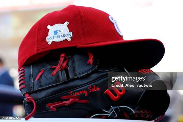 Detail shot of the hat and glove of Sammy Solis of the Washington Nationals prior to Game 1 of the National League Division Series against the...