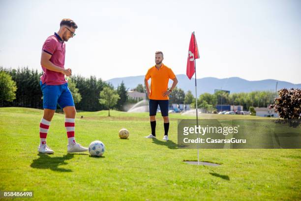 dos joven deportista jugando footgolf - ballenato fotografías e imágenes de stock
