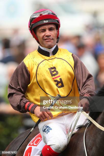 Michael Walker winks after riding Main Stage to win the UCI Stakes during Turnbull Stakes Day at Flemington Racecourse on October 7, 2017 in...