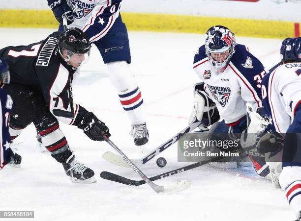 Goaltender Beck Warm of the Tri-City Americans makes a save on Ty Ronning of the Vancouver Giants during the first period of their WHL game at the...