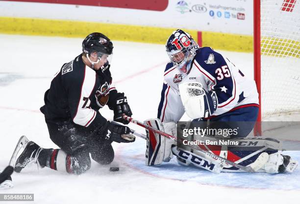 Goaltender Beck Warm of the Tri-City Americans makes a save on Ty Ronning of the Vancouver Giants during the first period of their WHL game at the...