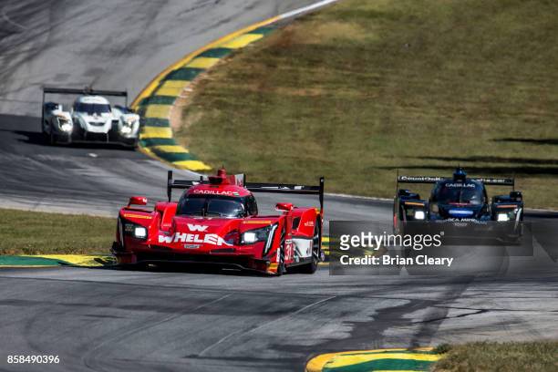 The Cadillac DPi of Dane Cameron, Eric Curran, and Michael Conway, of Great Britain, races on the track during practice for the Motul Petit Le Mans...