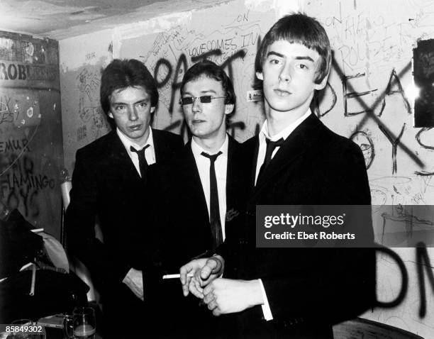 Bruce Foxton, Rick Buckler, Paul Weller of English punk band The Jam, posed, group shot in black suits, backstage at CBGB's, New York, 15th October...