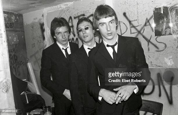 Bruce Foxton, Rick Buckler, Paul Weller of English punk band The Jam, posed, group shot in black suits, backstage at CBGB's, New York, 15th October...