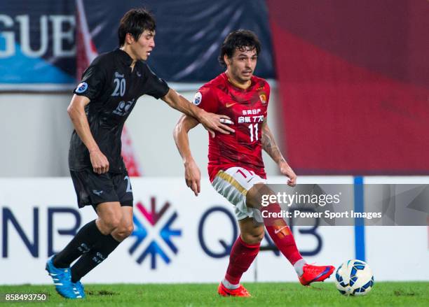 Guangzhou Evergrande midfielder Goulart Pereira fights for the ball with Seongnam FC defender Young Sun during the AFC Champions League 2015 2nd Leg...