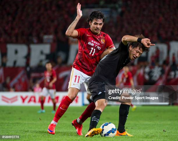 Guangzhou Evergrande midfielder Goulart Pereira fights for the ball with Seongnam FC defender Lim Chaimin during the AFC Champions League 2015 2nd...