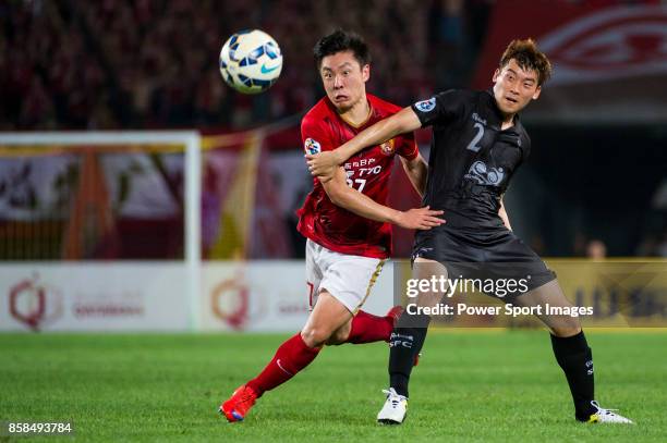 Guangzhou Evergrande midfielder Zheng Long fights for the ball with Seongnam FC defender Kwak Haeseong during the AFC Champions League 2015 2nd Leg...