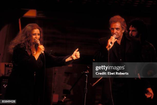 Photo of June CARTER and Johnny CASH, Johnny Cash and wife June Carter Cash performing on stage at the Bob Dylan 30th Anniversary concert