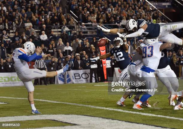 Corbin Kaufusi of the Brigham Young Cougars tries to block the punt of Joel Velazquez of the Boise State Broncos in the first half at LaVell Edwards...