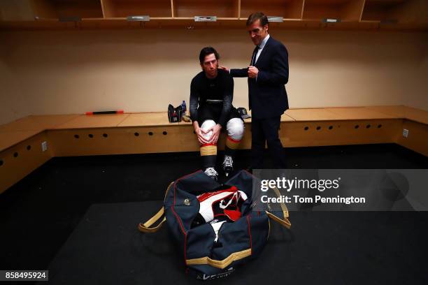 James Neal of the Vegas Golden Knights talks with Vegas Golden Knights general manager George McPhee in the locker room after scoring the first two...
