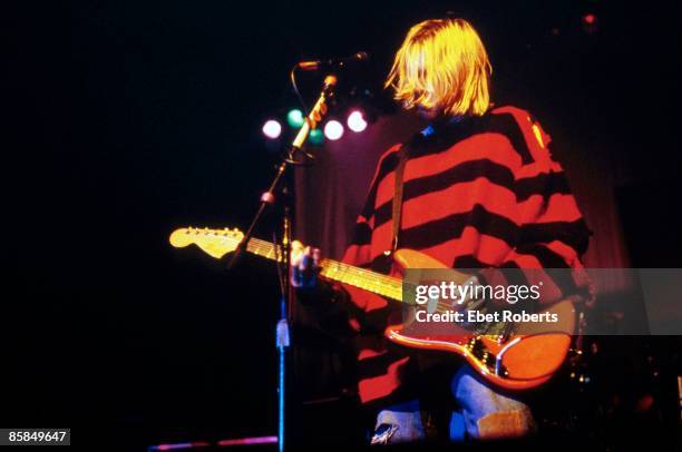 Kurt COBAIN and NIRVANA; Kurt Cobain performing live onstage at Roseland Ballroom, New Music Seminar, wearing stripy jumper, playing Fender Mustang...