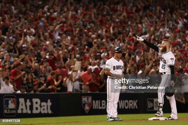 Archie Bradley of the Arizona Diamondbacks reacts after hitting a RBI triple during the seventh inning of the National League Wild Card game against...