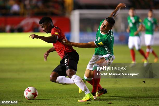 Carlos Salcedo of Mexico struggle for the ball against Kevon Villaroel of Trinidad & Tobago during the match between Mexico and Trinidad & Tobago as...