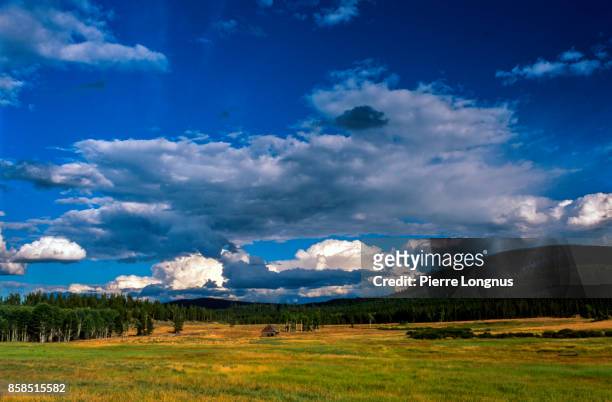 dramatic sky after un thunderstorm above a field and an old barn, along cariboo hwy, from williams lake to prince george, british columbia, canada - cariboo stock pictures, royalty-free photos & images