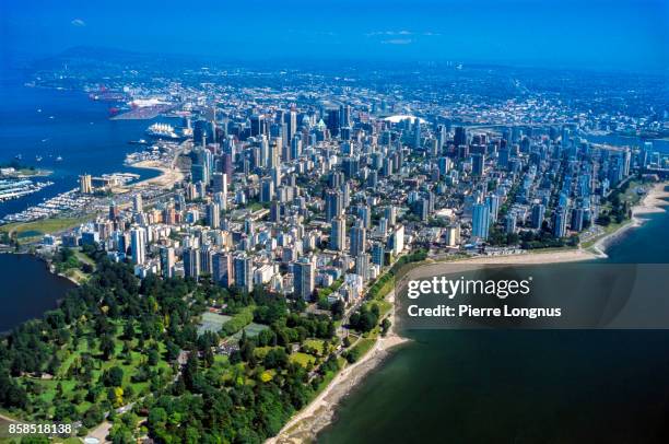aerial view of vancouver, english bay, stanley on the right, stanley park at the front and burrard inlet and the harbor on the left. - stanley park vancouver canada stock pictures, royalty-free photos & images