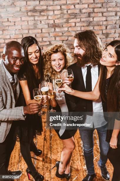 friends toasting at the party for the new year - the beat the chic party stock pictures, royalty-free photos & images