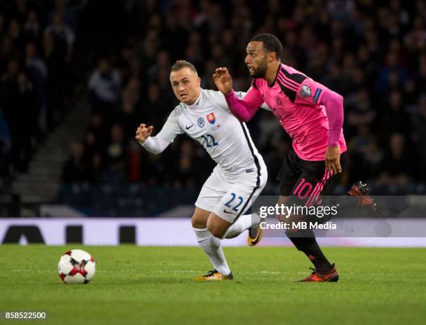 Stanislav Lobotka of Slovakia and Matt Phillips of Scotland compete for the ball during the match between Scotland and Slovakia at Hampden Park on...