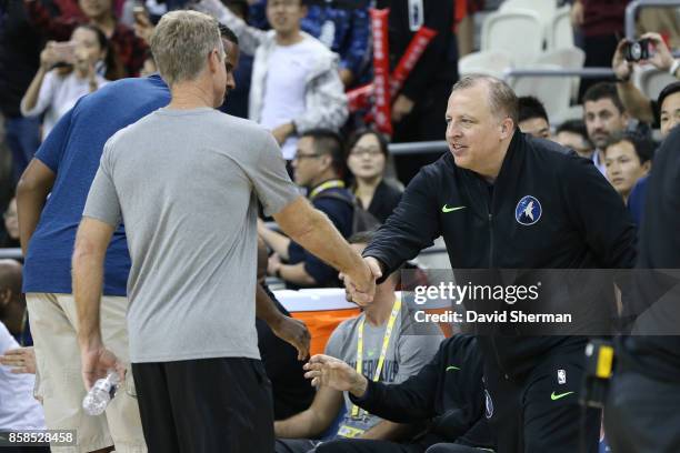 Steve Kerr of the Golden State Warriors shakes hands with Tom Thibodeau of the Minnesota Timberwolves during fan day as part of 2017 NBA Global Games...