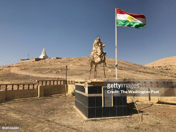 Skeletal statue of a Yazidi luminary, which was destroyed by Islamic State militants, is still in ruins nearly a year after the extremists were...