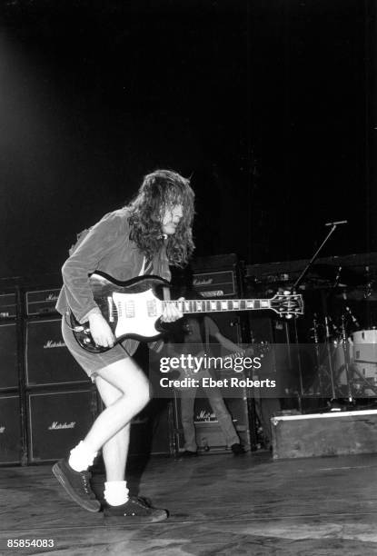 Photo of Angus YOUNG and AC/DC, Angus Young performing on stage