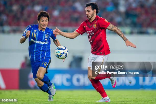 Guangzhou Evergrande midfielder Ricardo Goulart fights for the ball with Gamba Osaka defender Yonekura Koki during the AFC Champions League 2015 Semi...