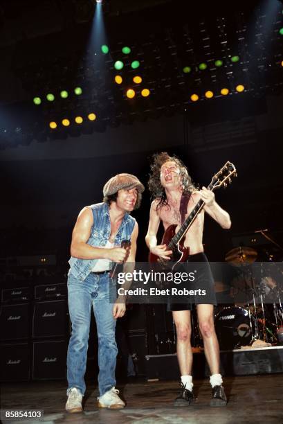 Photo of Angus YOUNG and Brian JOHNSON and AC/DC; L-R Brian Johnson and Angus Young performing on stage