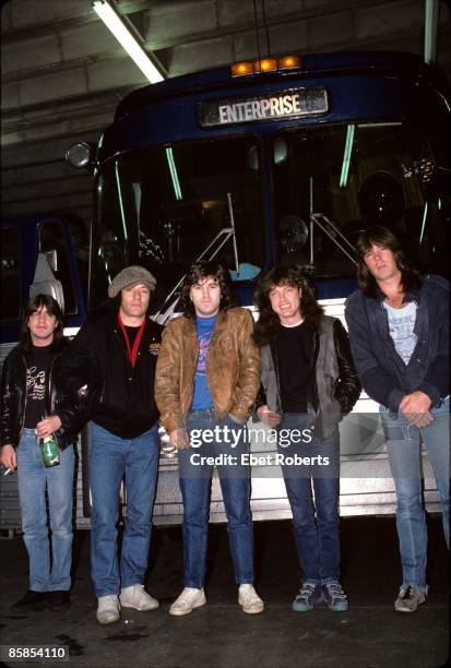 Photo of Cliff WILLIAMS and Angus YOUNG and Simon WRIGHT and Malcolm YOUNG and AC/DC and Brian JOHNSON; Group portrait backstage, tour bus L-R Malcom...