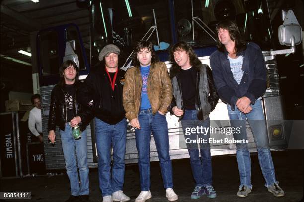 Photo of Cliff WILLIAMS and Angus YOUNG and Simon WRIGHT and Malcolm YOUNG and AC/DC and Brian JOHNSON; Group portrait backstage, tour bus L-R Malcom...