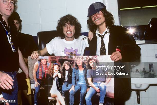 Photo of Angus YOUNG and AC/DC, Angus Young backstage with an impersonator