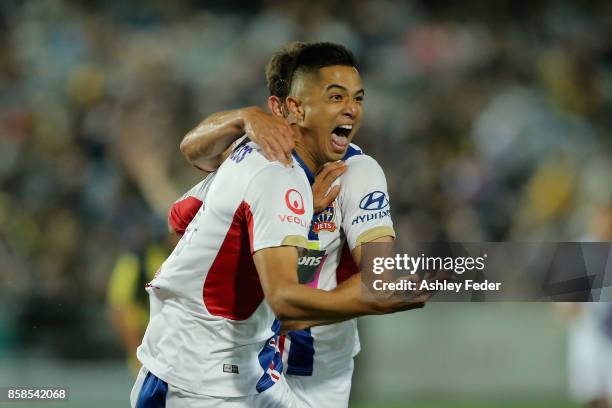 Joseph Champness and Benjamin Kantarovski of the Jets celebrate a goal by Joseph Champness during the round one A-League match between the Central...