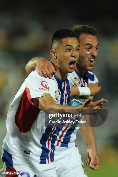 Joseph Champness and Benjamin Kantarovski of the Jets celebrate a goal by Joseph Champness during the round one A-League match between the Central...