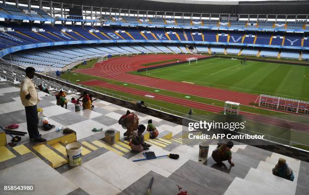 Indian labourers work at Salt Lake Stadium, officially known as Vivekananda Yuba Bharati Krirangan , ahead of the FIFA U-17 World Cup in Kolkata on...