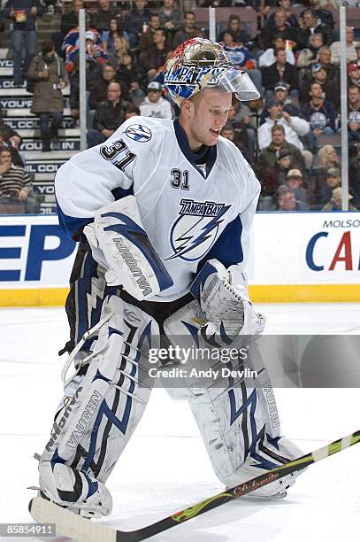 Karri Ramo of the Tampa Bay Lightning retrieves his stick during a stoppage of play against the Edmonton Oilers at Rexall Place on February 24, 2009...