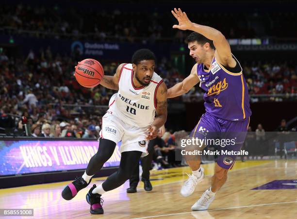 Ramone Moore of the 36ers drives pase Kevin Lisch of the Kings during the round one NBL match between the Sydney Kings and the Adelaide 36ers at...