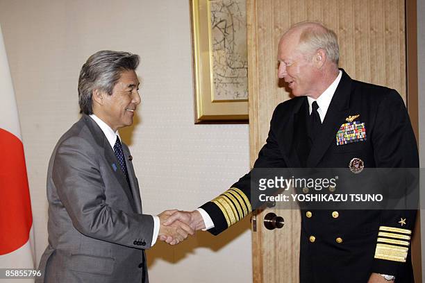 Robert Willard , commander of the US Pacific Fleet shakes hands with Japanese Foreign Minister Hirofumi Nakasone prior to their talks at Nakasone's...