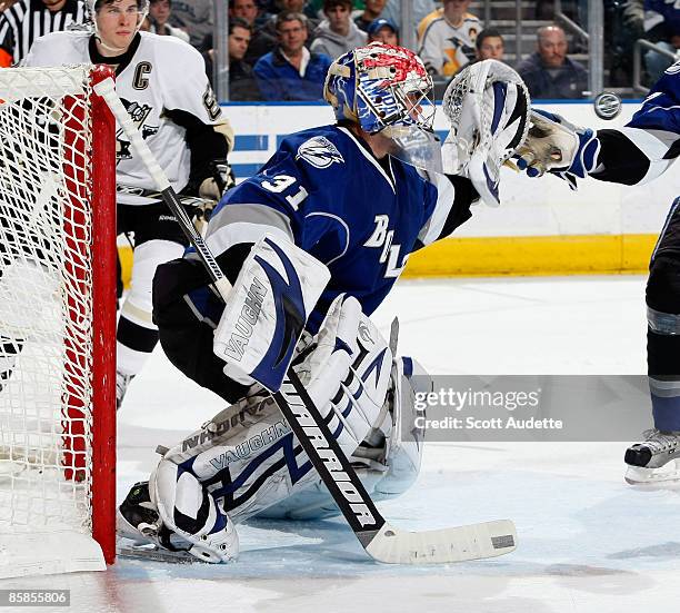 Goaltender Karri Ramo of the Tampa Bay Lightning makes a glove save against the Pittsburgh Penguins at the St. Pete Times Forum on April 7, 2009 in...