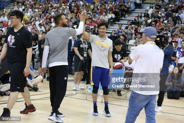 Stephen Curry of the Golden State Warriors and Chen Bolin high five during fan day as part of 2017 NBA Global Games China on October 7, 2017 at the...