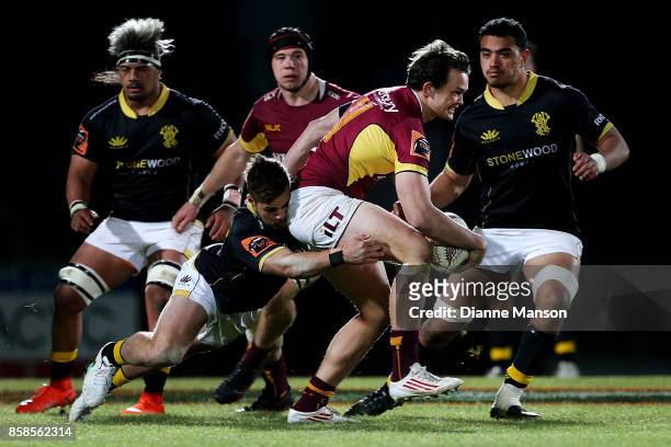 Lewis Ormond of Southland is tackled by Wes Goosen of Wellington during the round eight Mitre 10 Cup match between Southland and Wellington at Rugby...